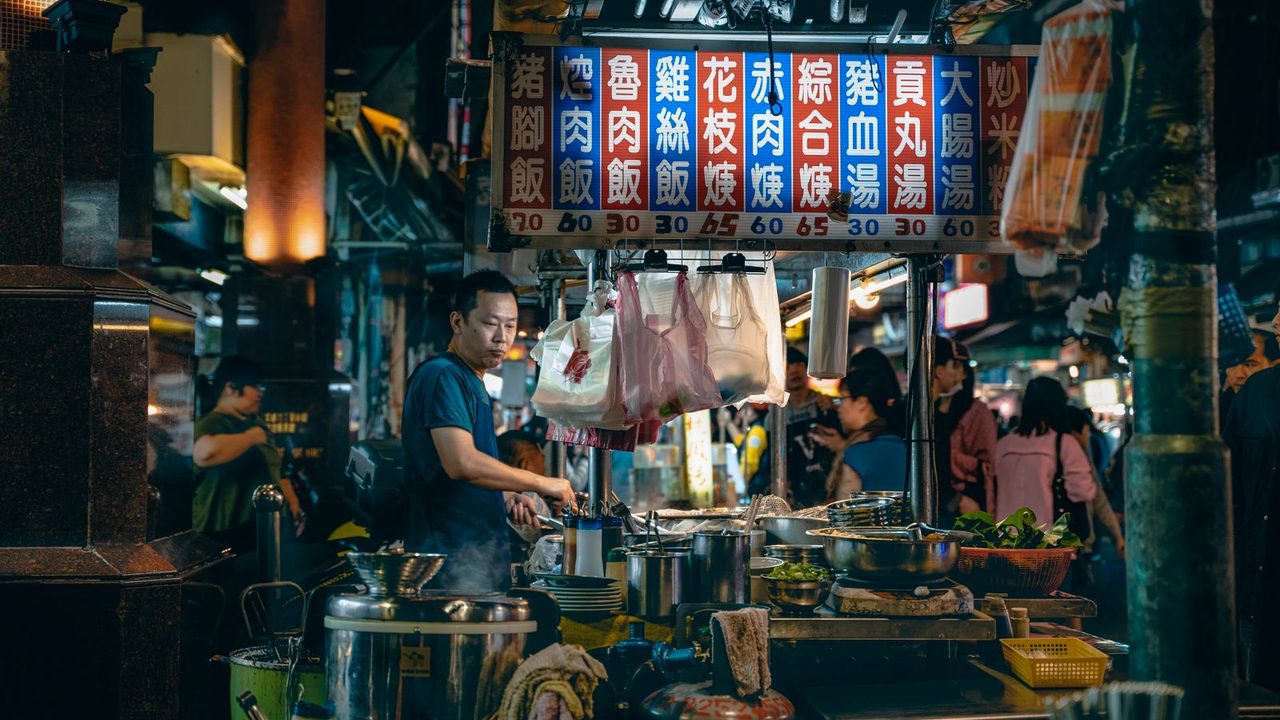 An Asian hawker stall with Chinese menu boards — the kind of food culture Taman Desa is known for
